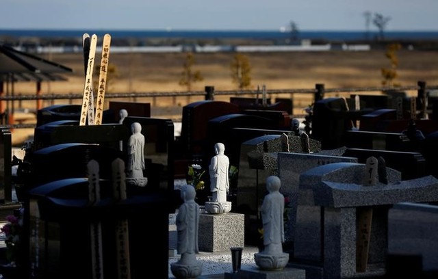 Stone statues of Jizo and gravestones are seen near a seaside devastated by the March 11, 2011 tsunami in Namie town near Tokyo Electric Power Co's (TEPCO) tsunami–crippled Fukushima Daiichi nuclear power plant, Fukushima prefecture, Japan, February 28, 2017. Credit: Reuters