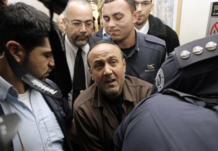 Jailed Fatah leader Marwan Barghouti (C) is accompanied by Israeli prison guards after a deliberation at Jerusalem Magistrate's court January 25, 2012. REUTERS/Ammar Awad/Files