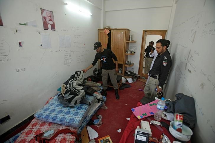 Police search the dorm room of Mashal Khan, accused of blasphemy, who was killed by a mob at Abdul Wali Khan University in Mardan, Pakistan April 14, 2017. Credit: Reuters/Fayaz Aziz