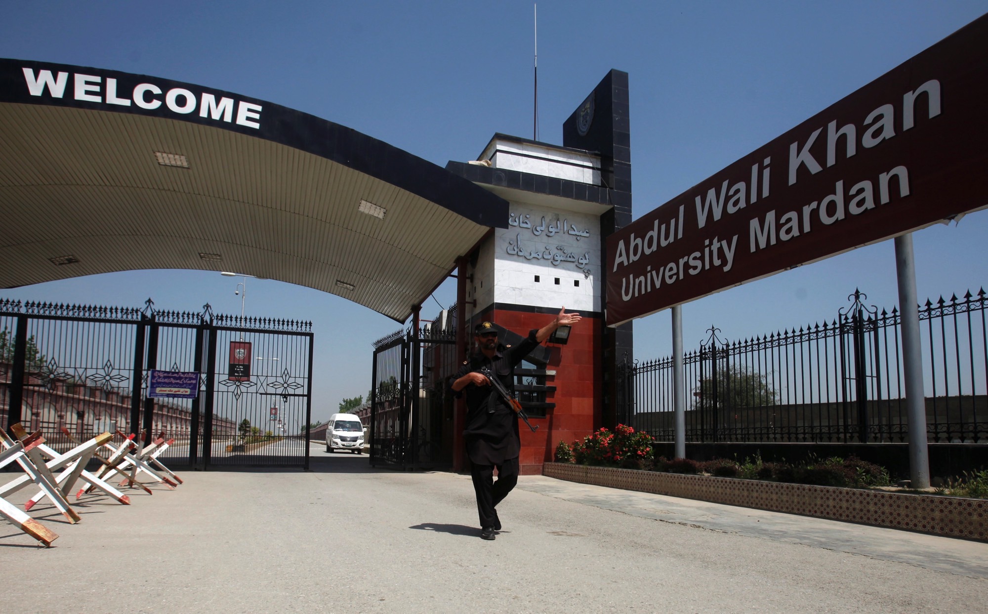 A policeman gestures as he stands guard at the entry of Abdul Wali Khan University where Mashal Khan, accused of blasphemy, was killed by a mob, in Mardan, Pakistan April 14, 2017. Credit: Reuters/Fayaz Aziz