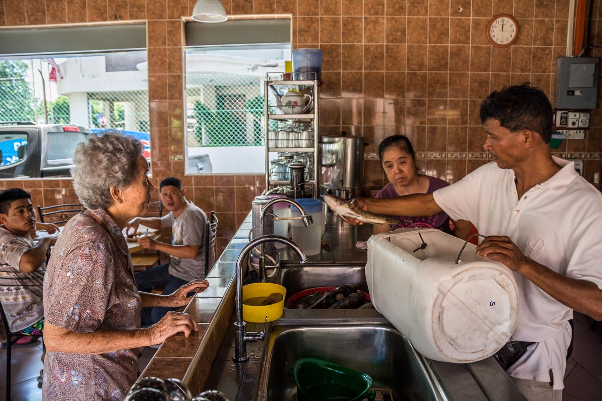 Penang fisherman Liew Hock Choon delivers his catch of grouper to a local restaurant keen to buy them. Credit: Rod Harbinson via Mongabay