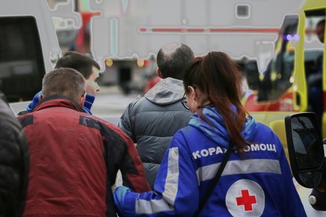 An injured person is helped by emergency services outside Sennaya Ploshchad metro station, following explosions in two train carriages at metro stations in St. Petersburg, Russia April 3, 2017. Credit: Reuters