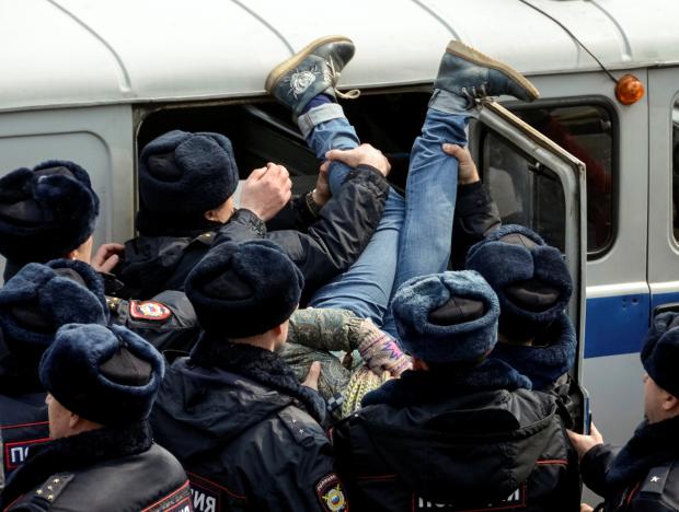 Police officers detain an opposition supporter during a rally in Vladivostok, Russia. Credit: Reuters/Yuri Maltsev