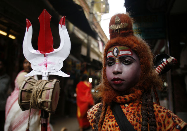 A boy dressed as Lord Shiva stands inside a temple during Mahashivratri festival in Trakeshawar, about 50 km (30 miles) west from Kolkata February 6, 2008. Credit:Jayanta Shaw/Reuters/Files