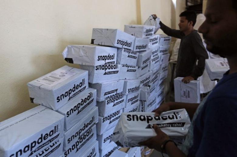 Employees of Snapdeal, an Indian online retailer, sort out delivery packages inside their company fulfilment centre in Mumbai October 22, 2014. Credit: Reuters
