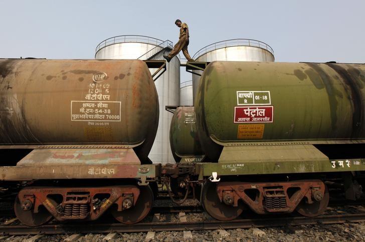 A worker walks atop a tanker wagon to check the freight level at an oil terminal on the outskirts of Kolkata November 27, 2013. REUTERS/Rupak De Chowdhuri/File Photo