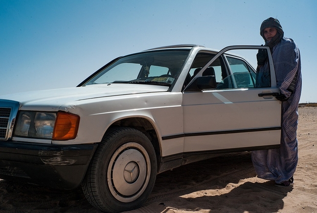 Hindu Mani delivers pizzas with her 1989 white Mercedes Benz in Aswerd camp, around 50 km from the Algerian city of Tindouf Credit: MEE/Eugenio G. Delgado