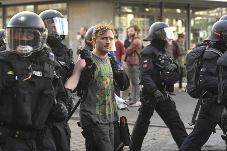 German riot police officers detain a protester during demonstrations at the G20 summit in Hamburg, Germany, July 8, 2017. Credit: Reuters/Fabian Bimmer