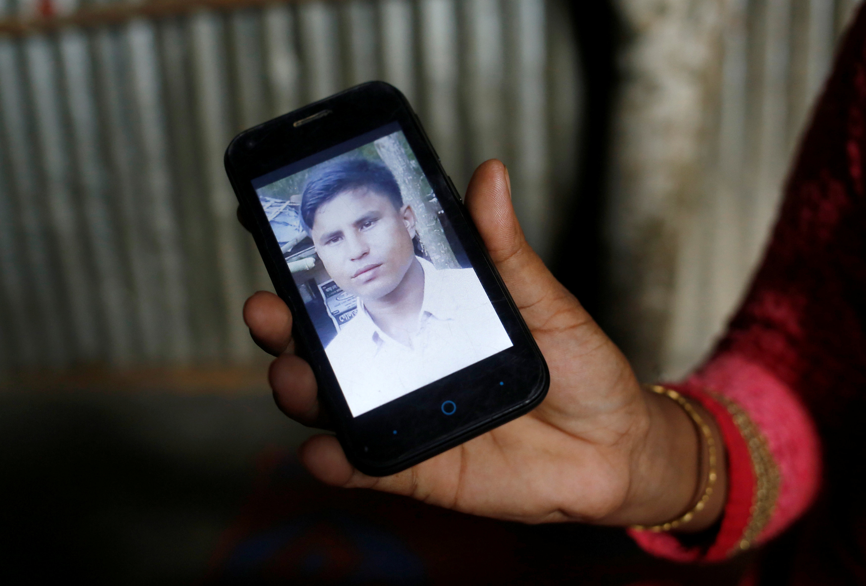 Noor Ankis shows the picture of her husband Ayub, a leader of the unregistered makeshift camp in Kutupalong, who was killed late last month, in Cox’s Bazar, Bangladesh, July 9, 2017. Credit: Reuters/Mohammad Ponir Hossain