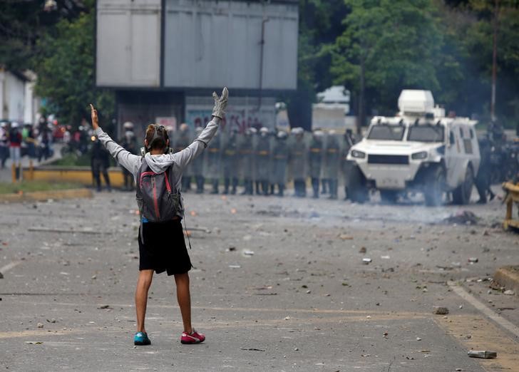 A demonstrator gestures towards riot security forces while rallying against Venezuela's President Nicolas Maduro's government in Caracas, Venezuela, July 22, 2017. Credit: Reuters/Andres Martinez Casares