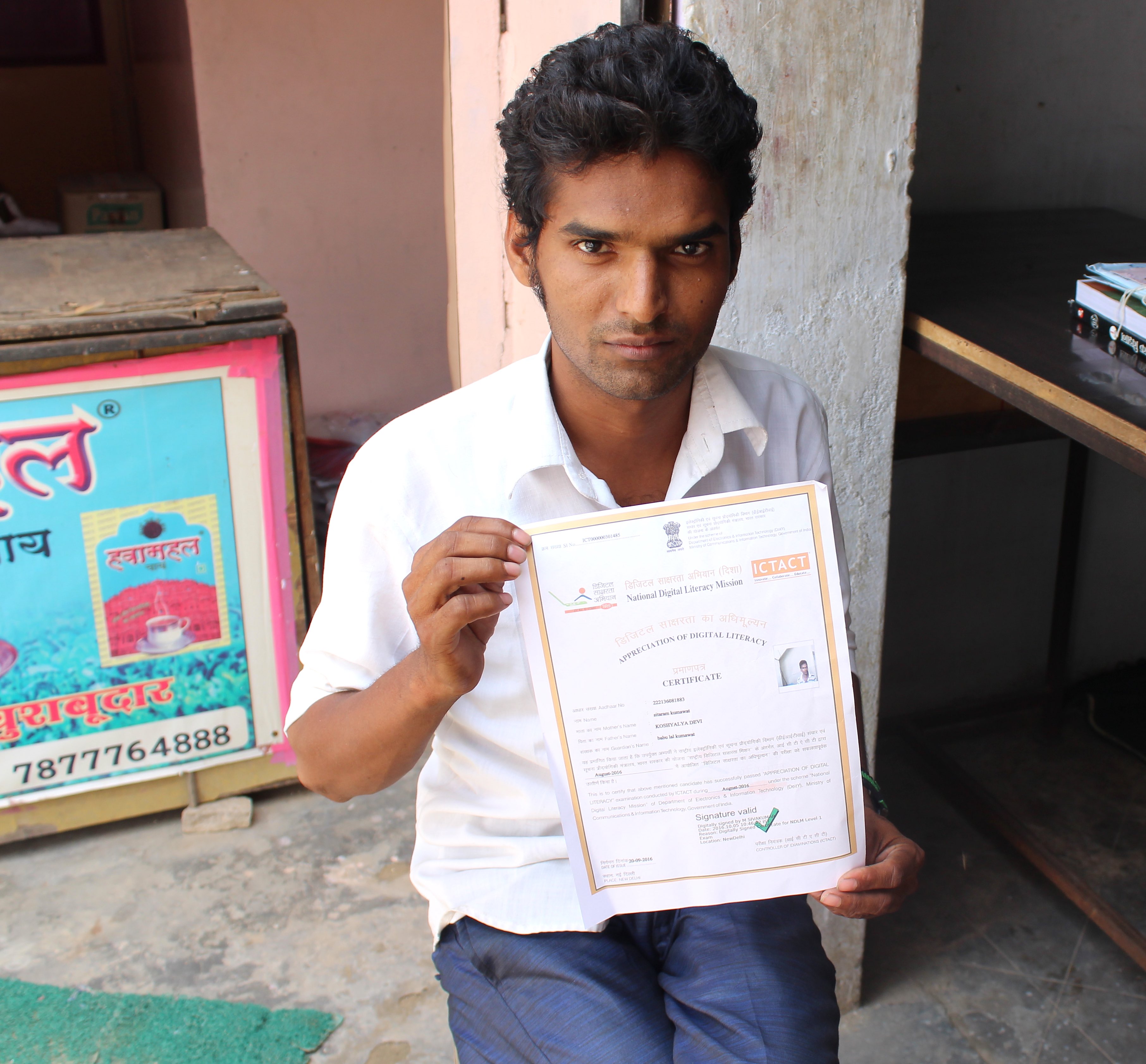 Sitaram showing his digital literacy certificate in Kalwar village. Credit: Shruti Jain