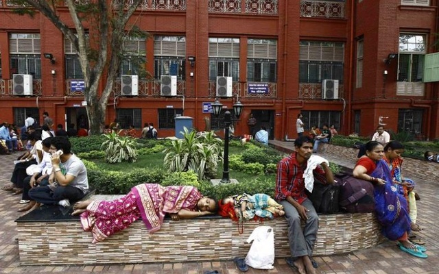 Relatives of patients wait outside a hospital in Kolkata. Credit: Reuters/Files