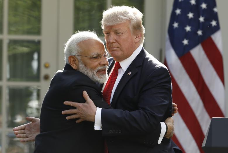 India's Prime Minister Narendra Modi hugs President Donald Trump as they give joint statements in the Rose Garden of the White House in Washington. Credit: Reuters/Kevin Lamarque