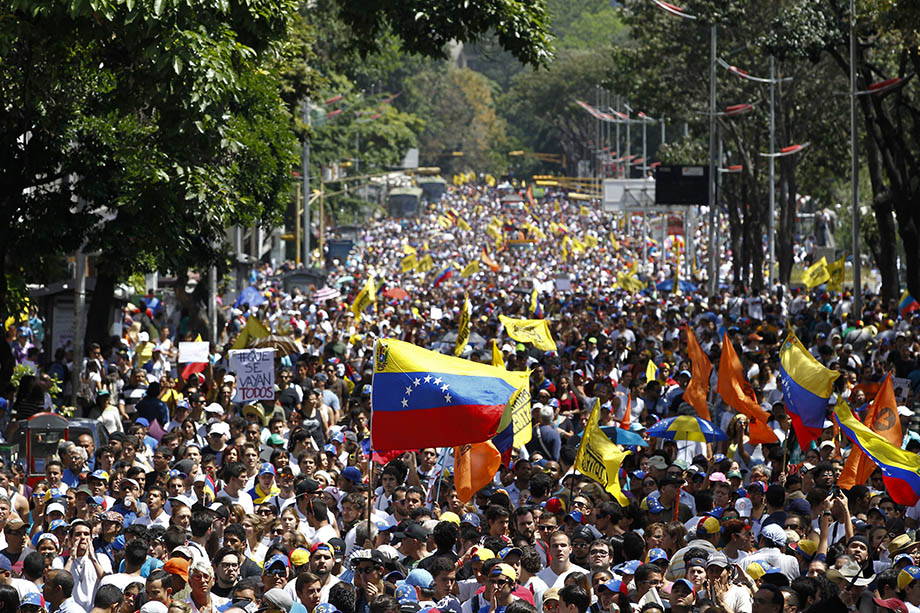 Opposition demonstrators on February 12. Armed pro-government groups attacked and shot at people protesting against Maduro's government late last Tuesday in the Andean city of Merida in western Venezuela, injuring five, activists said. Credit: Reuters