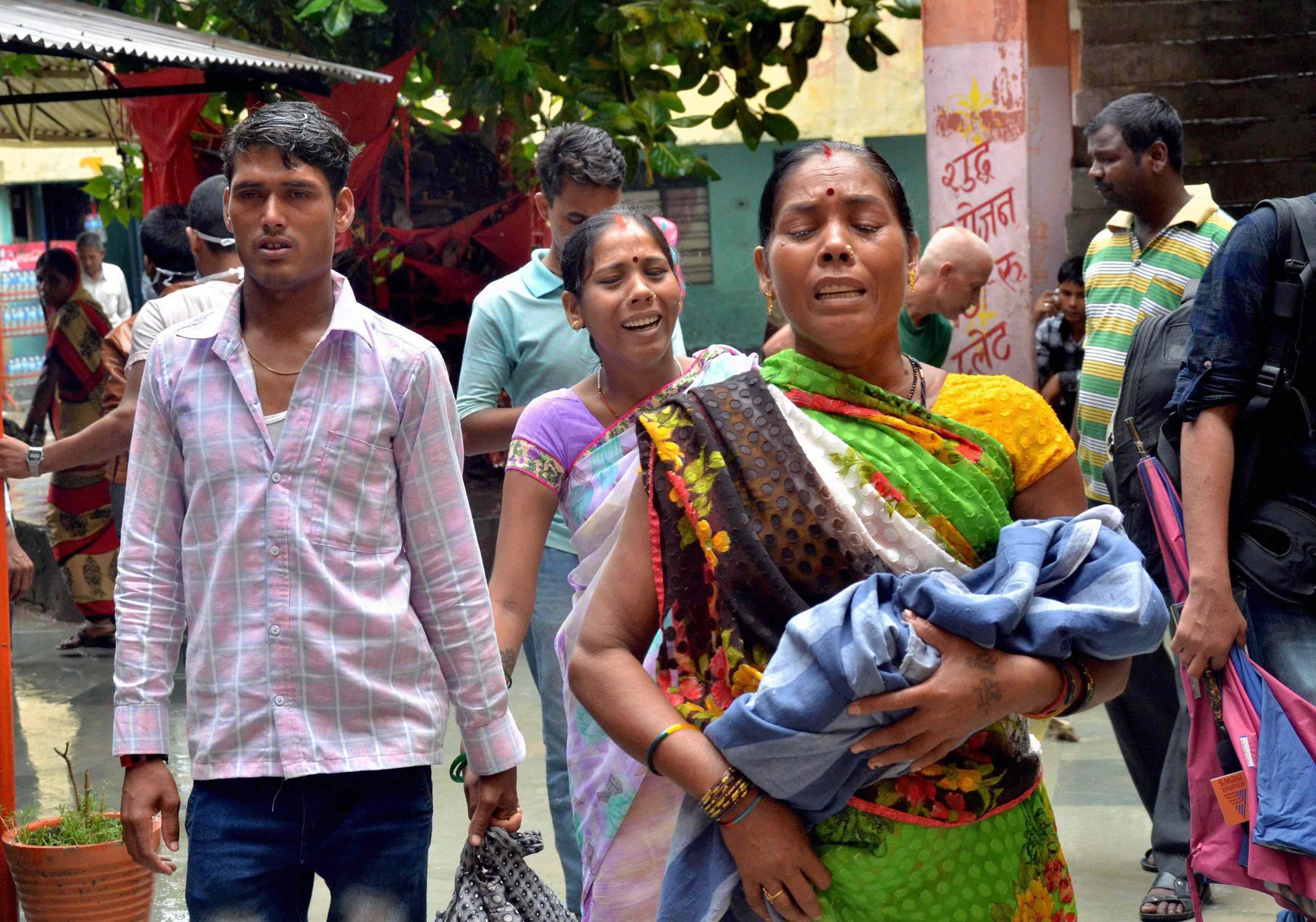 Relatives carry a child at the Baba Raghav Das Medical College Hospital in Gorakhpur. Credit: PTI
