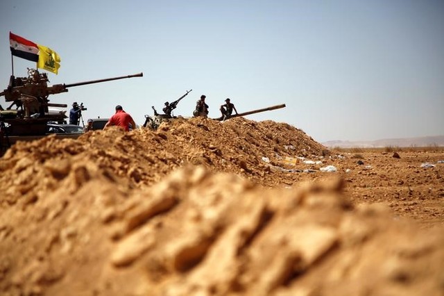 Hezbollah and Syrian flags flutter on a military vehicle in Western Qalamoun, Syria August 28, 2017. Credit:Reuters