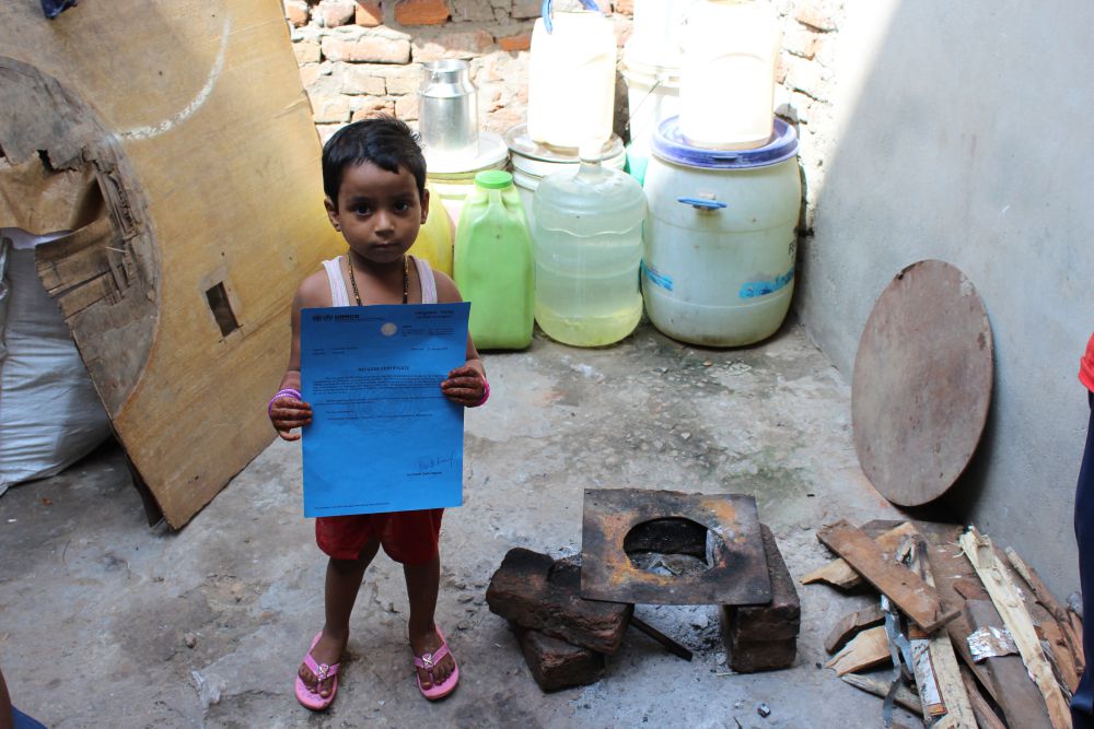 A Rohingya refugee holding his refugee certificate issued by UNHCR. Credit: Shruti Jain