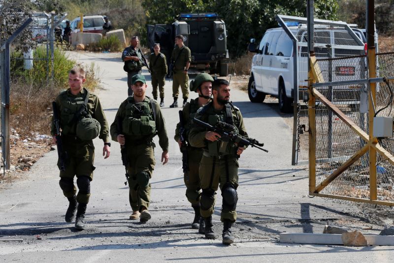 Israeli soldiers guard near the scene where a police spokeswoman said a Palestinian gunman killed three Israelis guards and wounded a fourth in an attack on a Jewish settlement in the occupied West Bank before himself being shot dead, September 26, 2017. Credit: Reuters/Ammar Awad