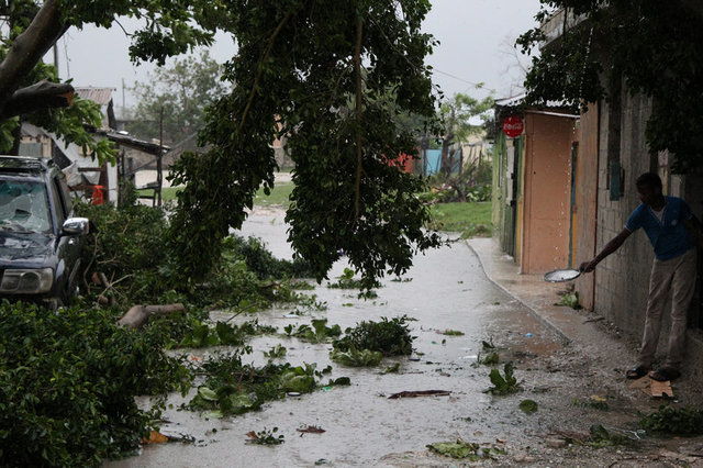 A child fills a plate with water aftermath of Hurricane Maria in Punta Cana, Dominican Republic, September 21, Credit: Reuters