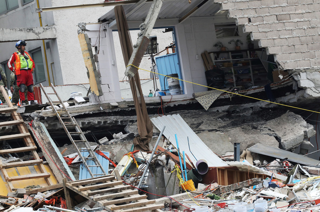 A member of rescue team looks on, in the rubble of a collapsed building, after an earthquake in Mexico City, Mexico September 25, 2017. Credit: Reuters
