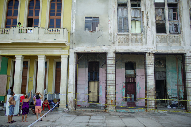 A family stay outside their home due to the risk of collapsing at the seafront Malecon after the passage of Hurricane Irma in Havana, Cuba, September 13, 2017. Credit: Reuters
