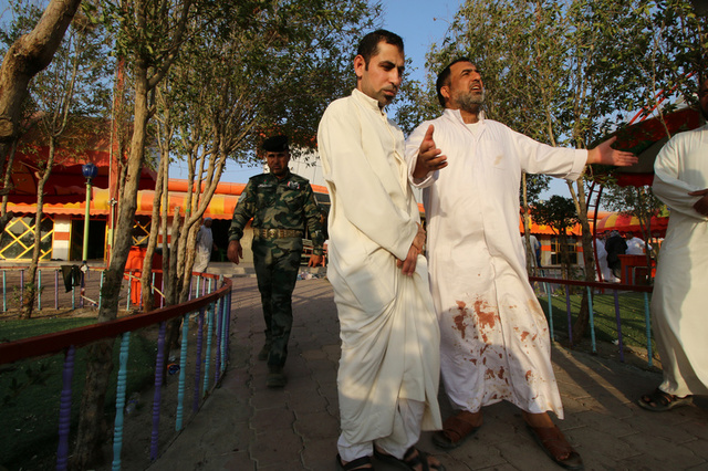 Iraqi people react at the site of a bomb attack in a restaurant in the southern Iraqi city of Nassiriya, Iraq, September 14, 2017. Credit: Reuters