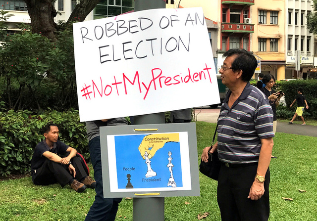 People take part in a protest against the uncontested presidential election at Hong Lim Park in Singapore September 16, 2017. Credit: Reuters
