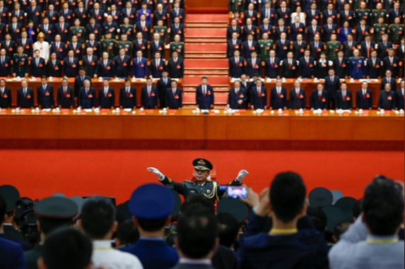 A conductor leads an orchestra as delegates stand for the national anthem during the closing session of the 19th National Congress of the Communist Party of China at the Great Hall of the People in Beijing, China, October, 24, 2017. Credit: Reuters/Thomas Peter