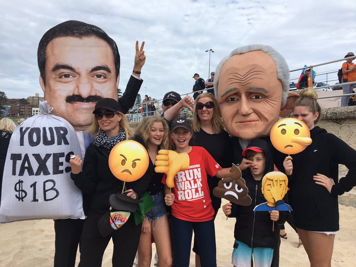 Protestors wear masks of Gautam Adani and Malcolm Turnbull, depicting the unpopular billion dollar government subsidy. Credit: Stop Adani Alliance