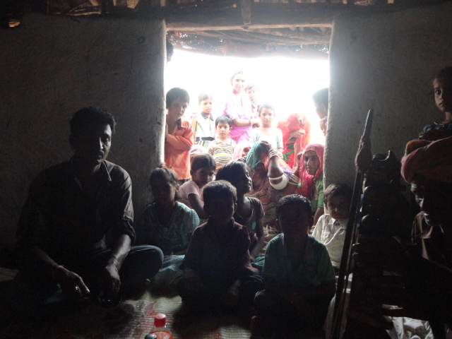 Villagers crowd his hut to hear him sing