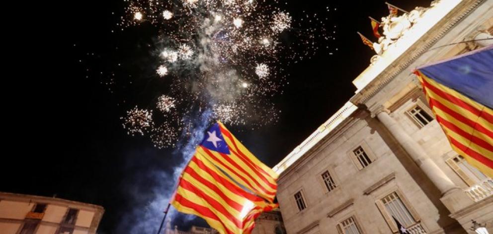Fireworks go off in front of the Catalan regional government headquarters during celebrations after the Catalan regional parliament declared independence from Spain in Barcelona. Credit: Reuters