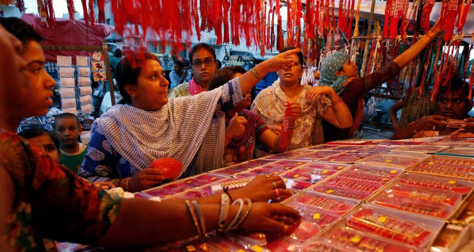 Women shop at a stall selling rakhis at a market in Ahmedabad