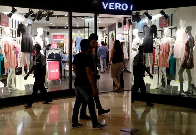 Shoppers walk past a store at a mall in Mumbai, India, July 10, 2017. Credit: Reuters