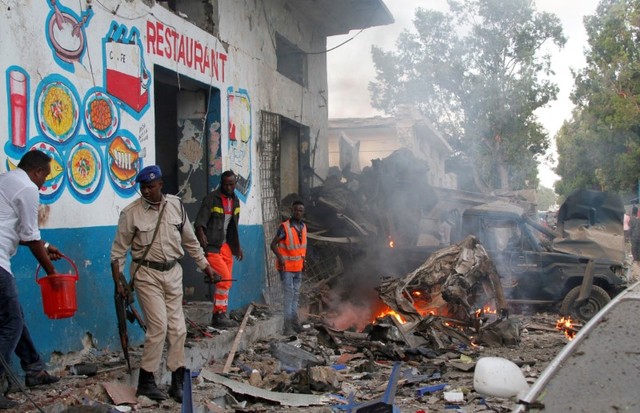 Somali security officers secure the scene of a suicide car bomb explosion, at the gate of Naso Hablod Two Hotel in Hamarweyne district of Mogadishu, Somalia October 28, 2017. Credit: Reuters