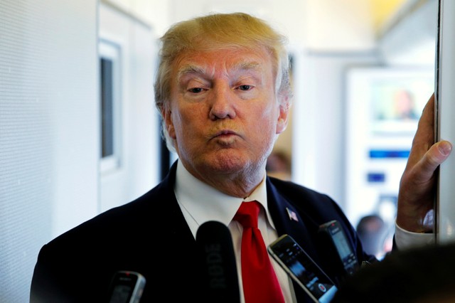 US President Donald Trump ponders the answer to a question from a reporter en route to Hanoi, Vietnam, aboard Air Force One November 11, 2017. Credit: Reuters/Jonathan Ernst