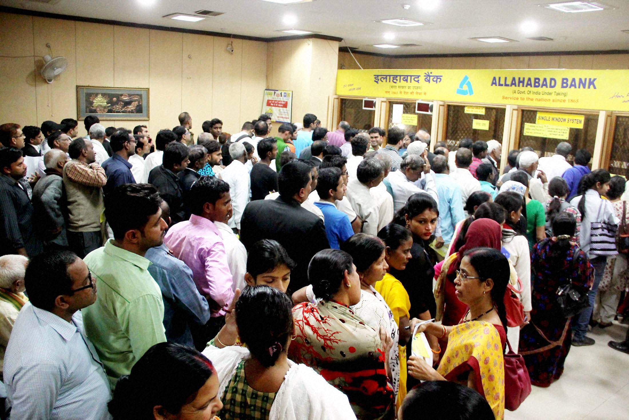 People wait in queues in a bank to exchange their 500 and 1000 currency notes in Allahabad