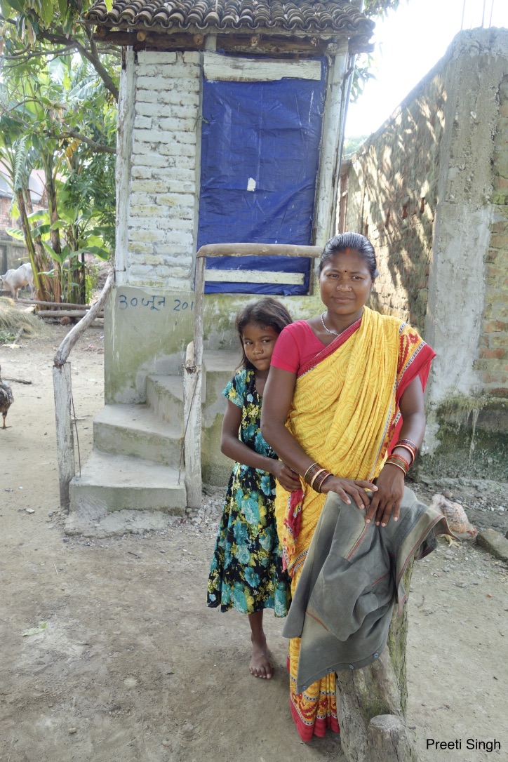 Puneeta Devi, a resident of Kairi village in Gaunaha block of Pashchim Champaran, has invested Rs 17,410 to build her own Phaydemand Shauchalaya. Her 12-year-old daughter, Reema Kumari, is most happy with the decision. Credit: Preeti Singh