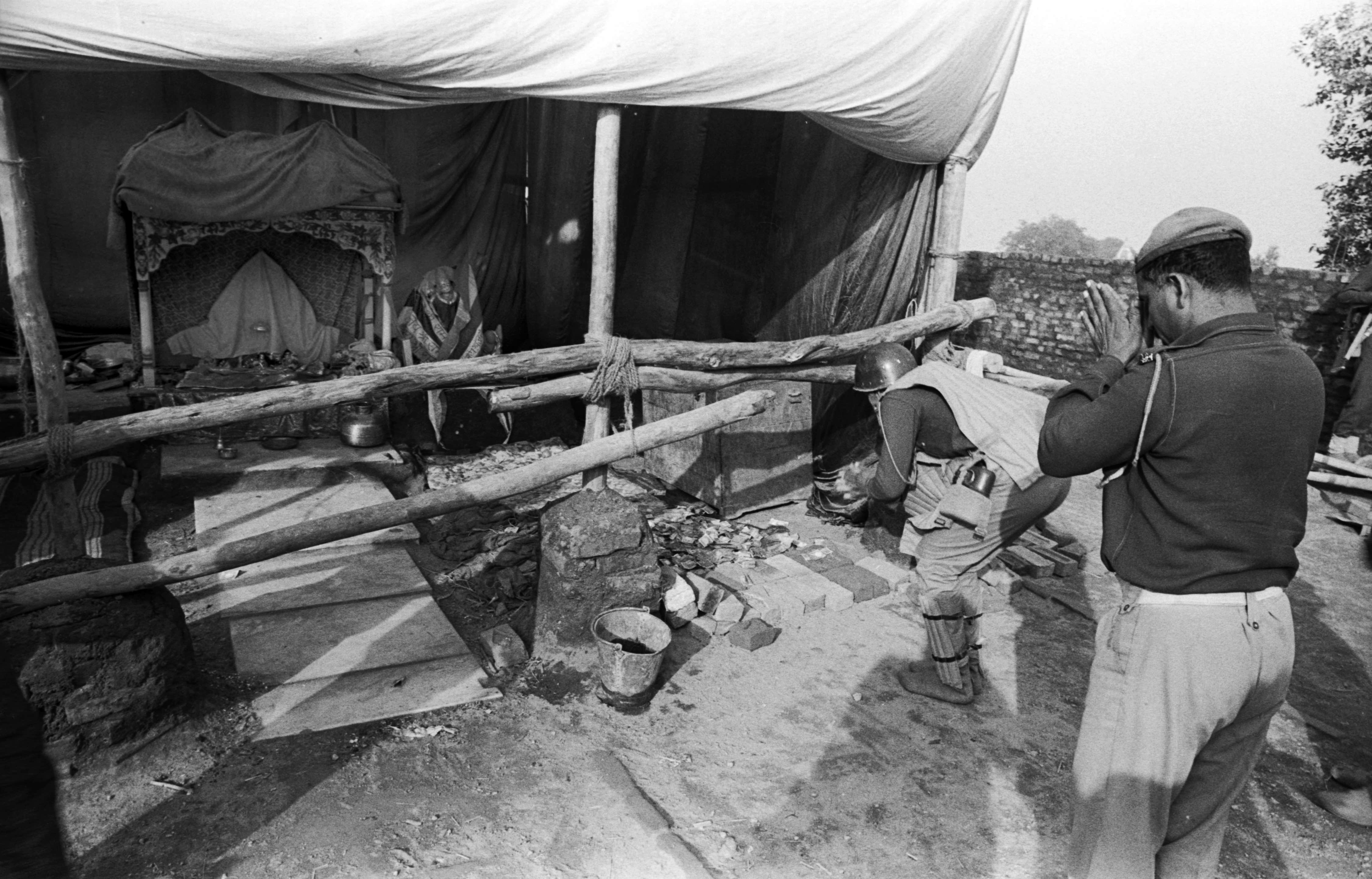 On the morning of December 7, 1992, paramilitary jawans pray at the makeshift temple which came up after the demolition of the Babri Masjid. Credit: T. Narayan