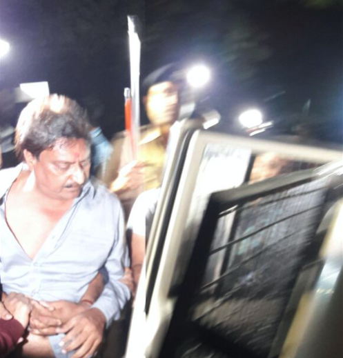 Indranil Rajguru being taken into police custody. Credit: Damayantee Dhar