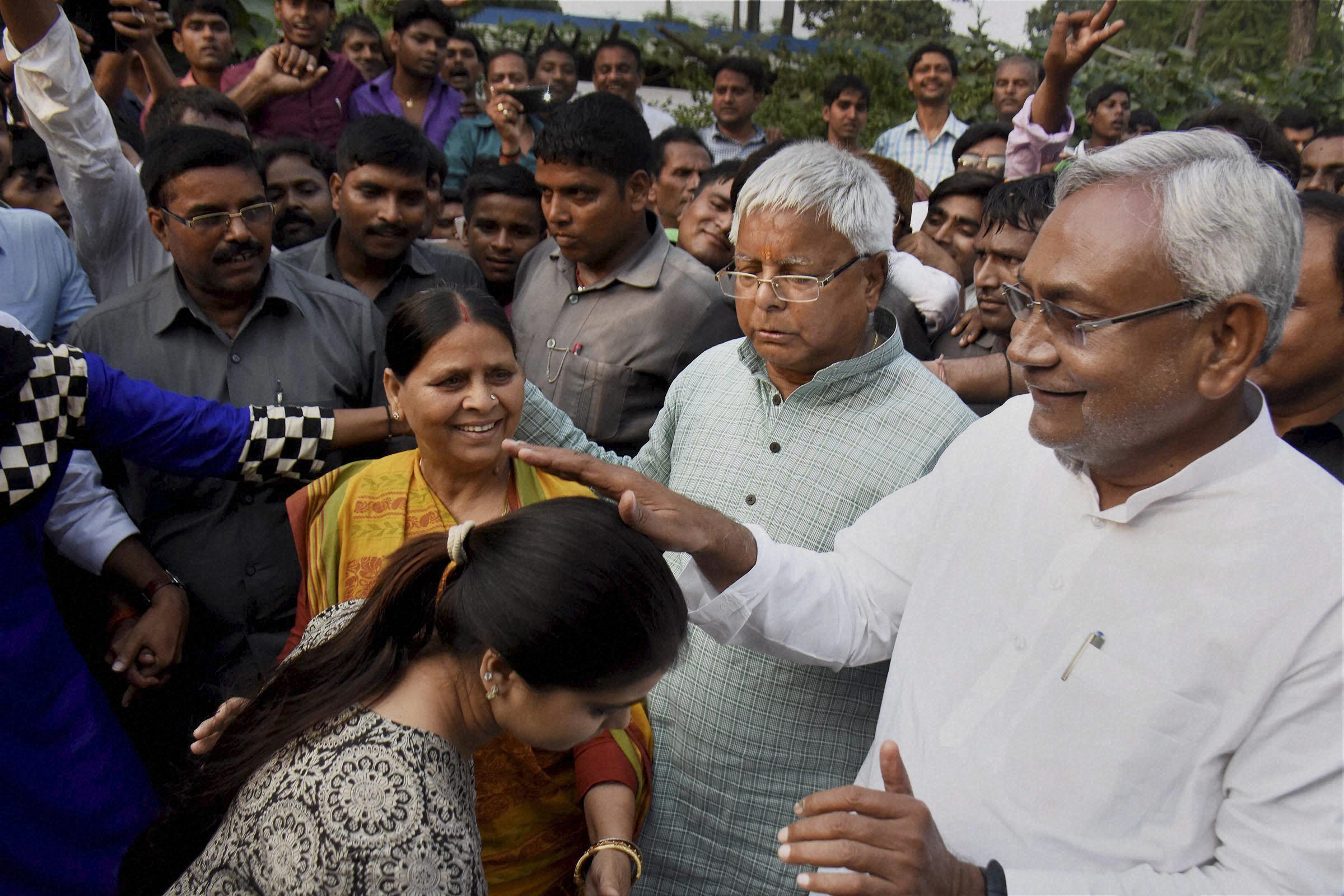 Bihar chief minister Nitish Kumar blessing a daughter of RJD chief Lalu Prasad (C) and Rabri Devi after the Mahagathbandhan's victory in the Bihar assembly elections in Patna on Sunday. Credit: PTI