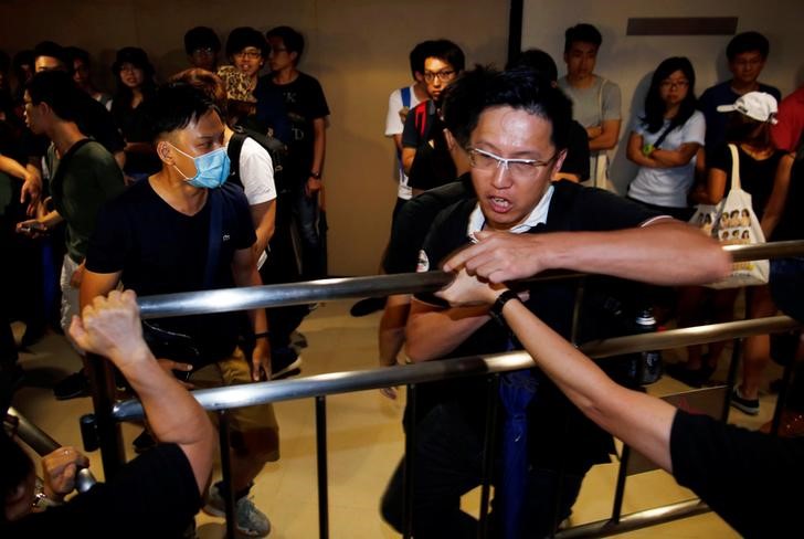 protestors disrupt hong kong election meeting over rule change