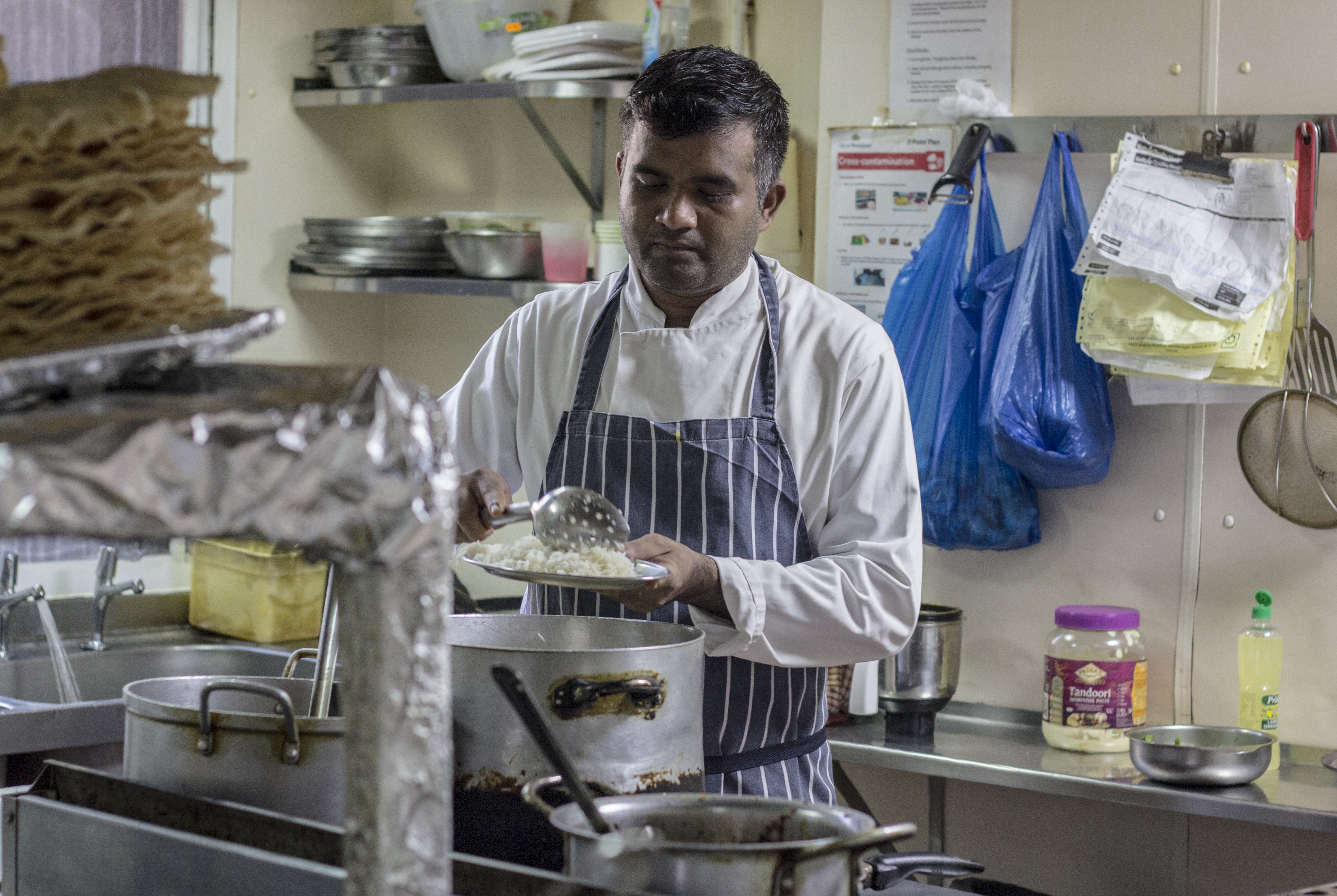 Asker, the head chef at the India Club Bar and Restaurant came to London 20 years ago from Kerala. Along with his colleague and friend Khaled, he never thought of working anywhere else other than the historic India Club. The menu offers a range of home-cooked Indian dishes and his version of the mango lassi is a favourite with customers. Credit: Paroma Mukherjee 