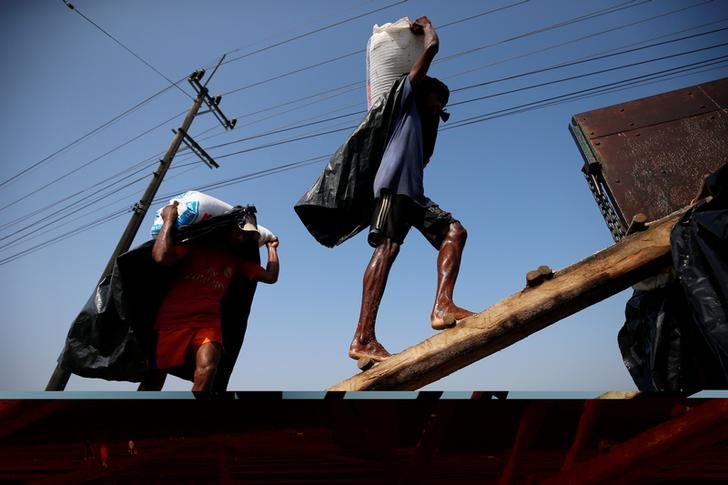 Rohingya refugee workers carry bags of salt as they work in processing yard in Cox's Bazar, Bangladesh. Picture taken on April 12, 2017. Credit: Reuters/Mohammad Ponir Hossain/Files