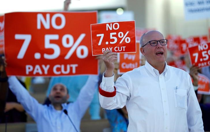 un geneva staff protest against proposed pay cut  call for strike