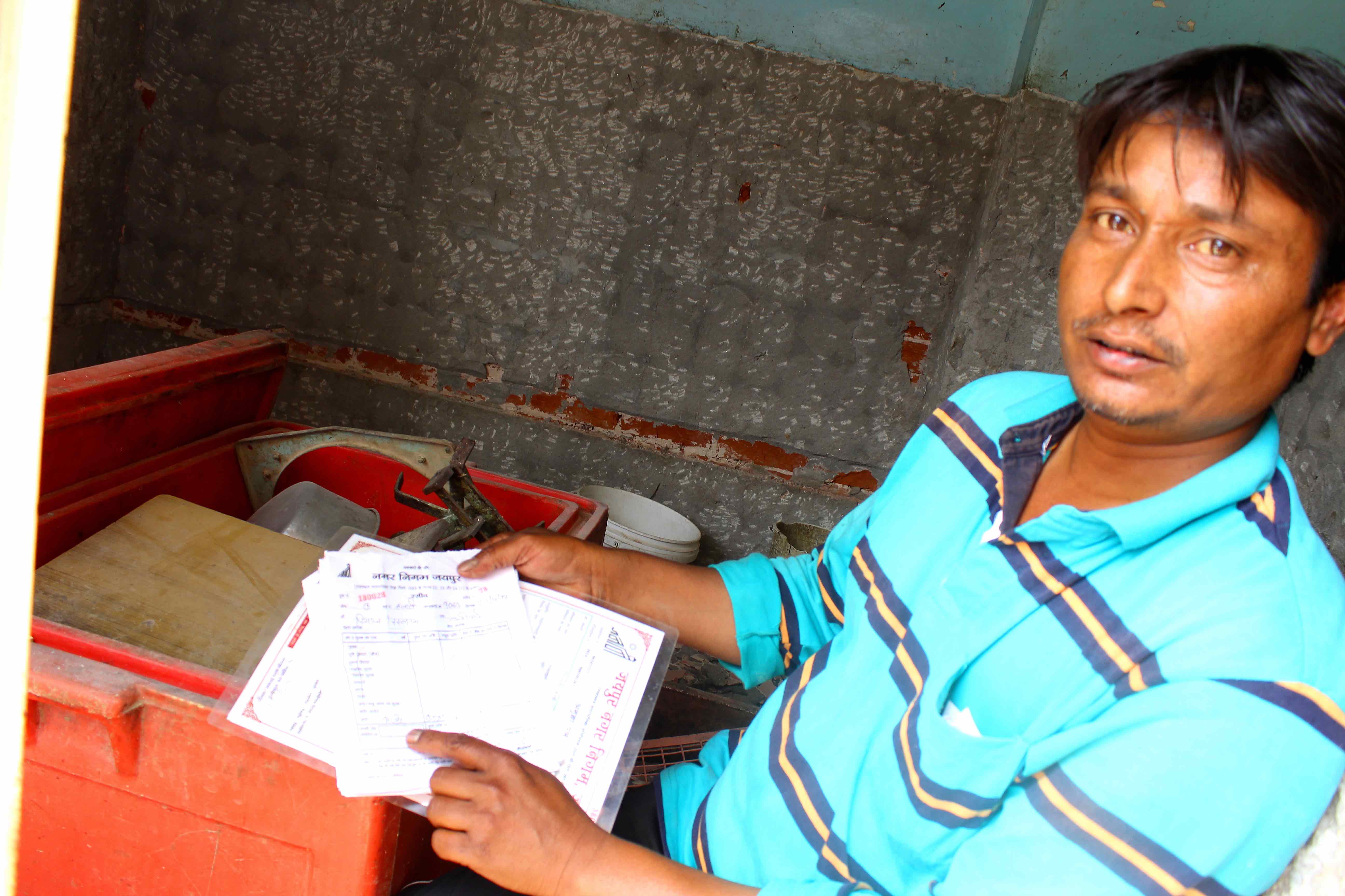 Riyazuddin Qureshi showing his licence and daily slips from the legal slaughterhouse. Credit: Shruti Jain