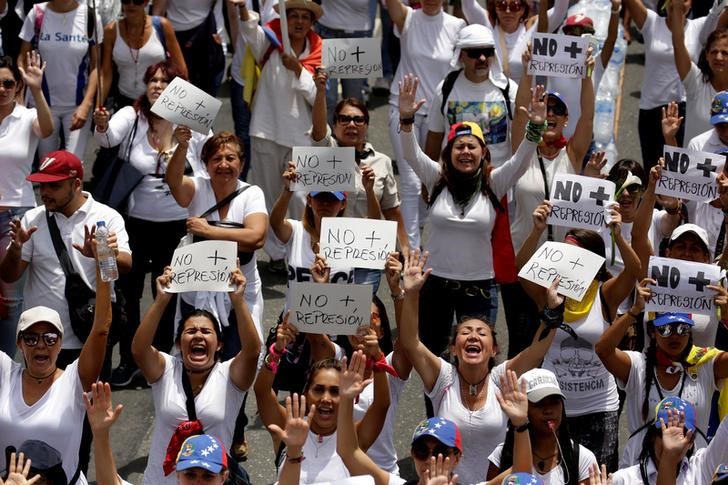 venezuelan women march in protest  offer roses to security forces