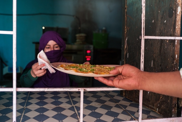 a sahrawi refugee woman is using her mercedes to deliver pizza