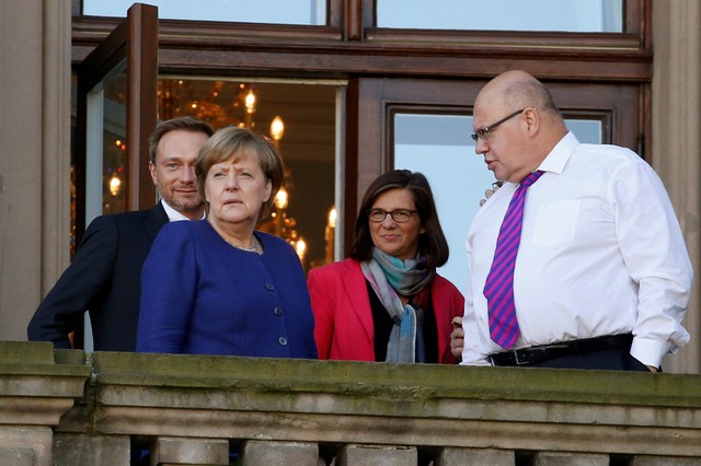 Chairman of the Free Democratic Party (FDP) Christian Lindner, leader of the Christian Democratic Union of Germany (CDU) Angela Merkel, leader of the German Green Party Katrin Goering-Eckardt and Chief of Staff of the German Chancellery Peter Altmaier are seen on a balcony of German Parliamentary Society offices during the exploratory talks about forming a new coalition government held by CDU/CSU in Berlin, Germany, October 30, 2017. Credit: Reuters/Axel Schmidt