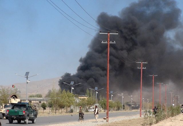 Smoke rises from police headquarters while Afghan security forces keep watch after a suicide car bomber and gunmen attacked the provincial police headquarters in Gardez, the capital of Paktia province, Afghanistan October 17, 2017. Credit: Reuters