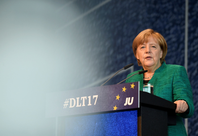 german chancellor merkel settles migrant row with allies to pursue coalition